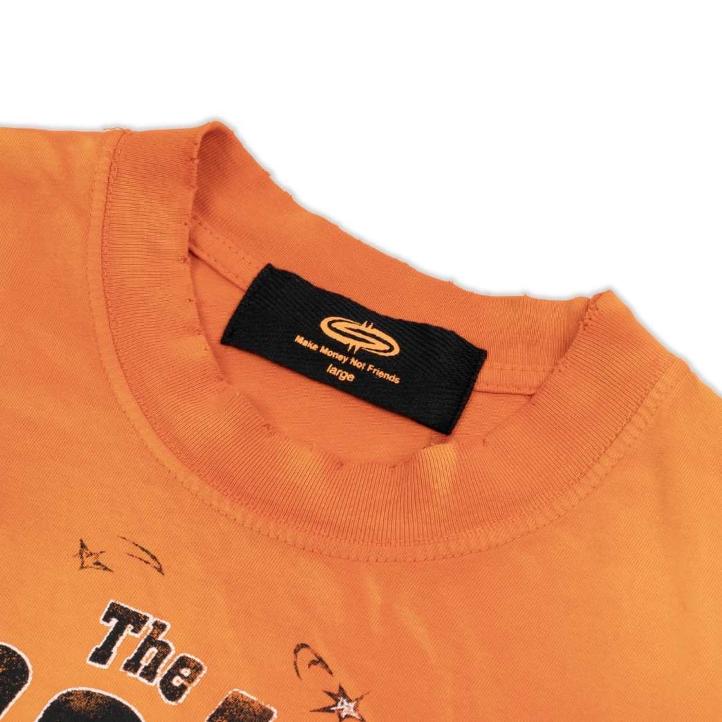 THE $MAKER COWBOYS WASHED TEE IN ORANGE